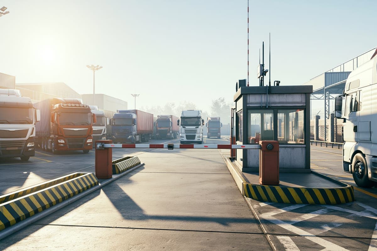 Trucks waiting at the barrier of the port gate beside the security booth